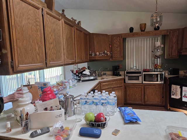 55305 Fairchild Rd, Macomb, MI 48042 - kitchen featuring stainless steel microwave, black range with electric cooktop, light countertops, lofted ceiling, and brown cabinets