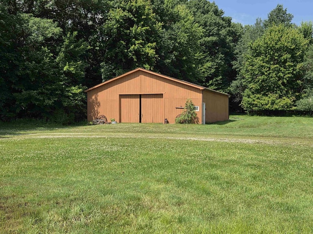 55305 Fairchild Rd, Macomb, MI 48042 - view of pole building featuring a lawn and a wooded view
