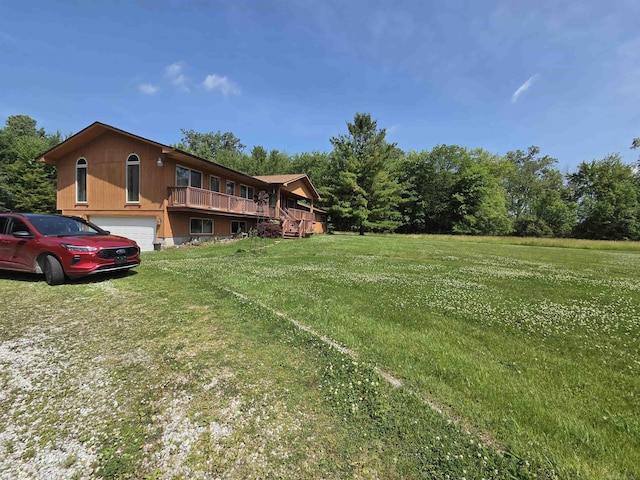 55305 Fairchild Rd, Macomb, MI 48042 - view of green lawn featuring a wooden deck and an attached garage