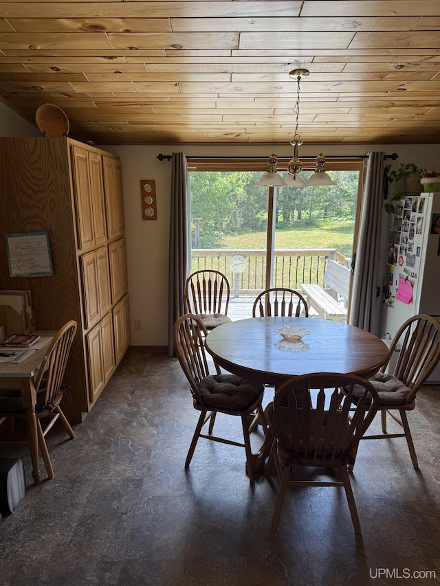 N7722 Candy Cane Rd, Munising, MI 49862 - dining space with wood ceiling, stone finish floors, and a chandelier