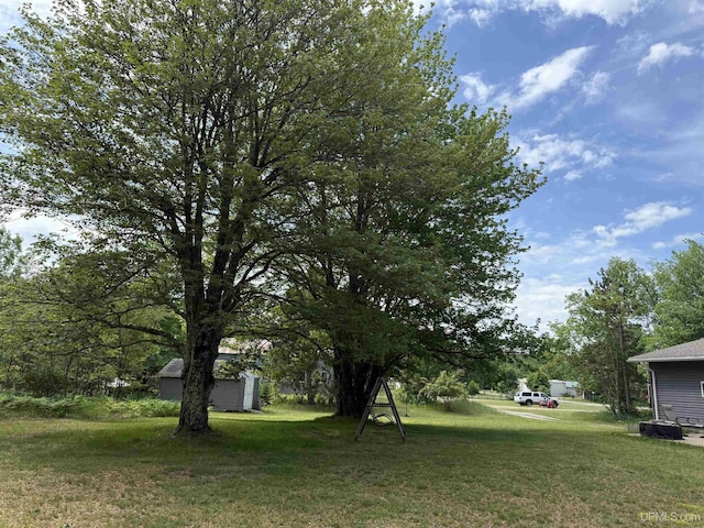 N7722 Candy Cane Rd, Munising, MI 49862 - view of grassy yard featuring a storage unit
