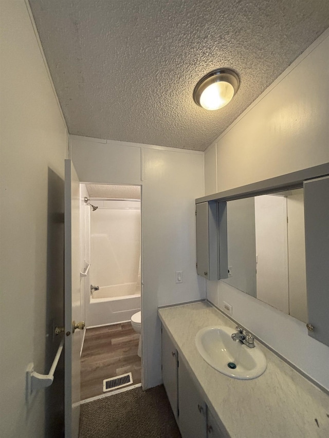 2299 Bart St, Croswell, MI 48422 - bathroom with a textured ceiling, vanity, shower / tub combination, and wood finished floors