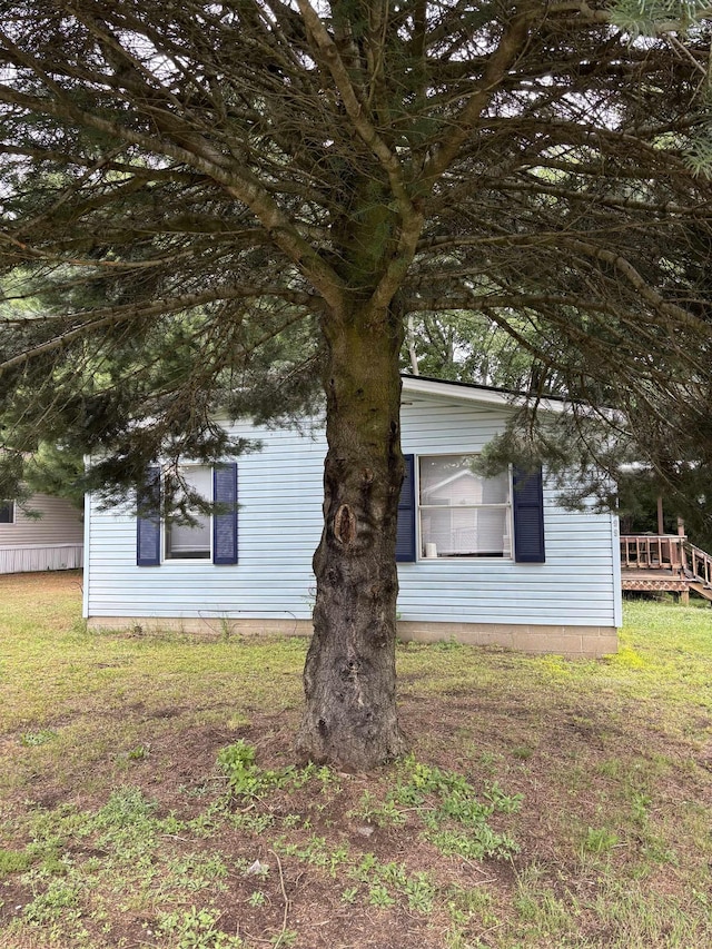2299 Bart St, Croswell, MI 48422 - view of side of home featuring a lawn and a wooden deck