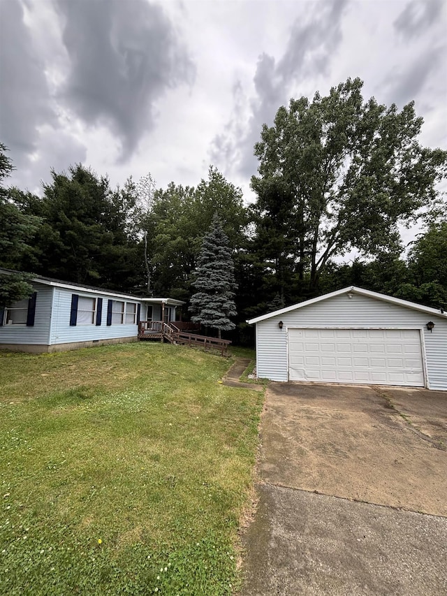 2299 Bart St, Croswell, MI 48422 - view of grassy yard featuring a detached garage, an outdoor structure, and view of scattered trees