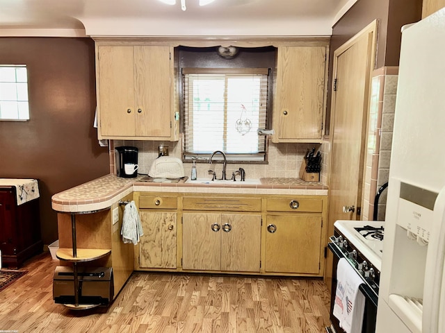 23311 Courtland Ave, Eastpointe, MI 48021 - kitchen featuring white appliances, light wood-style floors, tasteful backsplash, tile countertops, and light brown cabinets
