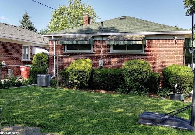23311 Courtland Ave, Eastpointe, MI 48021 - view of home's exterior featuring brick siding, a chimney, a yard, and a shingled roof