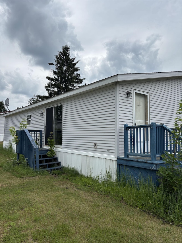 2266 Bart St, Croswell, MI 48422 - rear view of property featuring a wooden deck and a yard