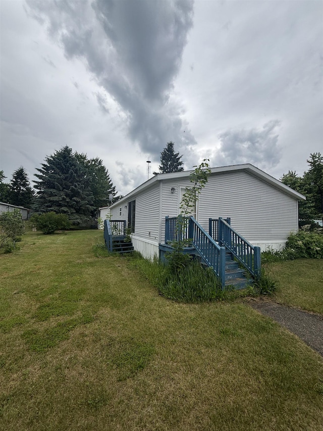 2266 Bart St, Croswell, MI 48422 - view of property exterior featuring a lawn and a wooden deck
