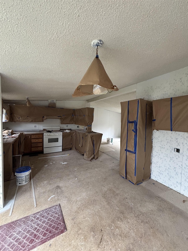 2266 Bart St, Croswell, MI 48422 - kitchen featuring white gas range and a textured ceiling