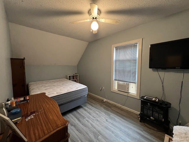 608 W Onota St, Munising, MI 49862 - bedroom with cooling unit, wood finished floors, a textured ceiling, ceiling fan, and lofted ceiling
