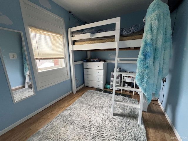 608 W Onota St, Munising, MI 49862 - bedroom with wood finished floors and baseboards