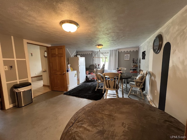 608 W Onota St, Munising, MI 49862 - dining room with a textured ceiling and concrete flooring
