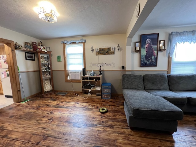 608 W Onota St, Munising, MI 49862 - living area with cooling unit, wood finished floors, and a textured ceiling
