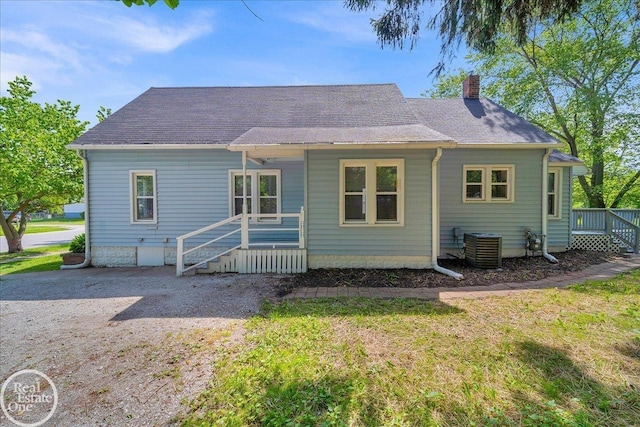 1118 Bancroft St, Port Huron, MI 48060 - back of property with a chimney, a porch, a lawn, and a shingled roof