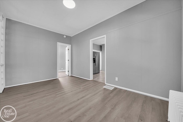 1118 Bancroft St, Port Huron, MI 48060 - spare room with wood finished floors and crown molding