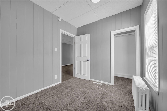 1118 Bancroft St, Port Huron, MI 48060 - unfurnished bedroom featuring carpet, radiator heating unit, multiple windows, and a closet