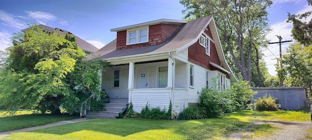 727 13th St, Port Huron, MI 48060 - view of front facade with a porch and a front yard