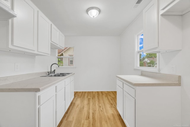 1404 Pine St, Port Huron, MI 48060 - kitchen with light wood finished floors, light countertops, and white cabinets