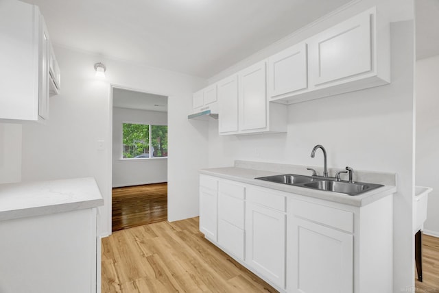 1404 Pine St, Port Huron, MI 48060 - kitchen featuring light wood finished floors, white cabinets, and light countertops