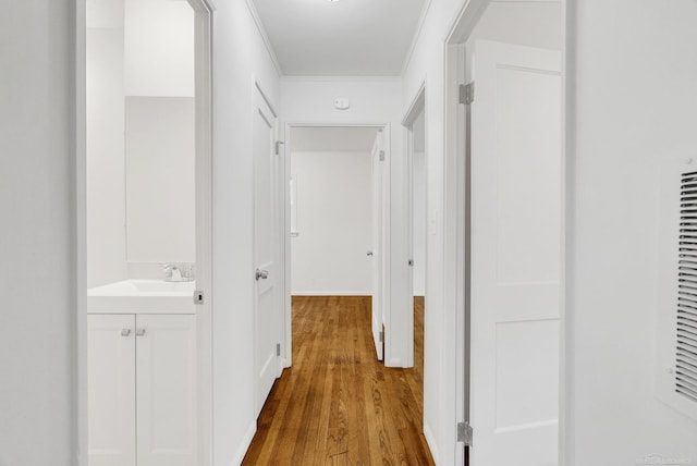 1404 Pine St, Port Huron, MI 48060 - hallway featuring wood finished floors and ornamental molding