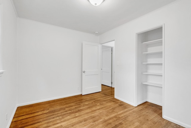 1404 Pine St, Port Huron, MI 48060 - unfurnished bedroom with light wood-style flooring, crown molding, and a closet