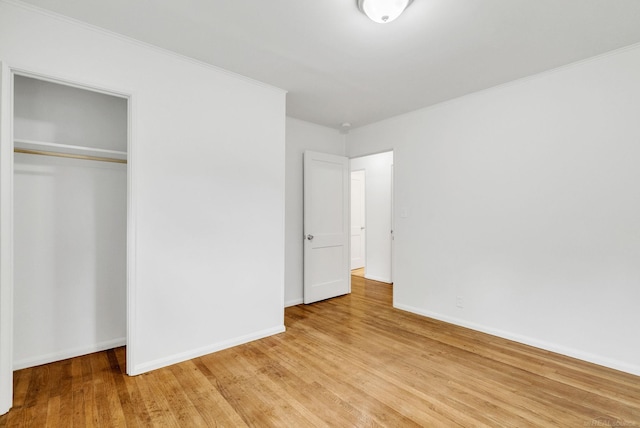 1404 Pine St, Port Huron, MI 48060 - unfurnished bedroom with light wood-type flooring, a closet, and crown molding