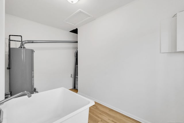 1404 Pine St, Port Huron, MI 48060 - laundry room featuring water heater, attic access, and light wood-style flooring