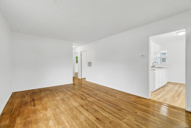 1404 Pine St, Port Huron, MI 48060 - unfurnished room with a sink and light wood-style flooring