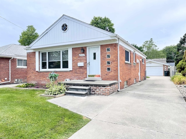 26315 Ursuline St, Saint Clair Shores, MI 48081 - bungalow with a front yard, an outdoor structure, a detached garage, and brick siding