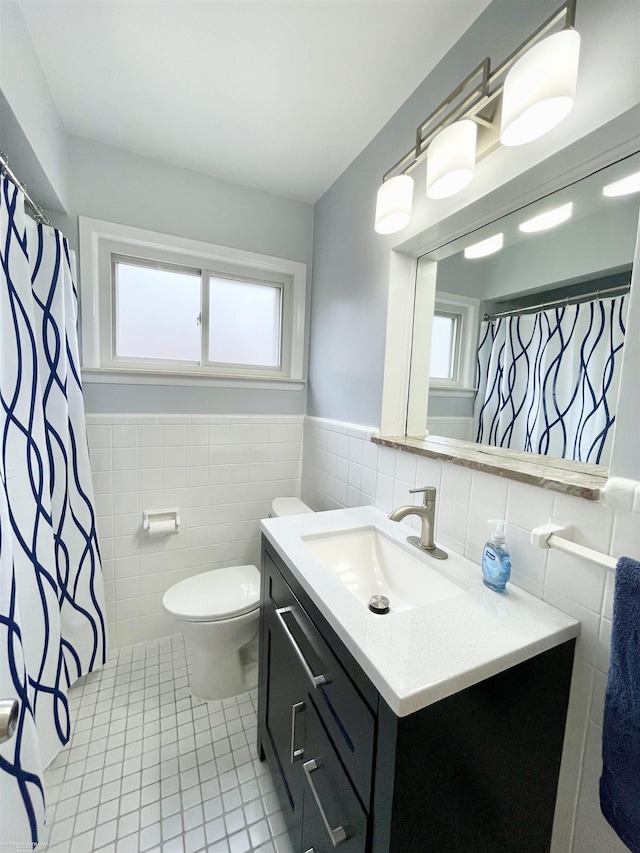 26315 Ursuline St, Saint Clair Shores, MI 48081 - full bathroom with tile walls, tile patterned floors, vanity, healthy amount of natural light, and a wainscoted wall