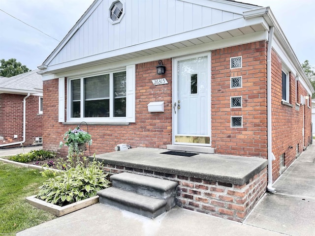 26315 Ursuline St, Saint Clair Shores, MI 48081 - property entrance featuring brick siding and board and batten siding
