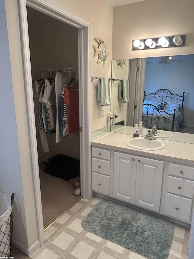 15 E Spring Ct Unit 12, Port Austin, MI 48467 - bathroom featuring vanity, a ceiling fan, a walk in closet, and tile patterned floors