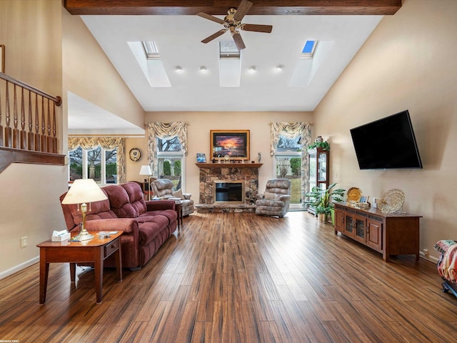 1008 Hidden Ln, Rochester Hills, MI 48309 - living area featuring a skylight, high vaulted ceiling, wood finished floors, ceiling fan, and a fireplace