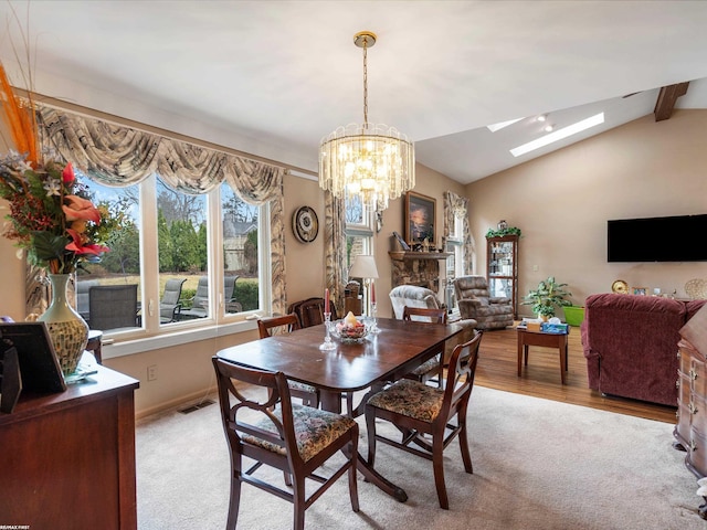 1008 Hidden Ln, Rochester Hills, MI 48309 - dining area featuring a skylight, a chandelier, light carpet, and light wood-style flooring