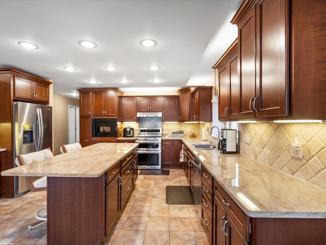 1008 Hidden Ln, Rochester Hills, MI 48309 - kitchen featuring appliances with stainless steel finishes, a breakfast bar, light stone countertops, a kitchen island, and recessed lighting