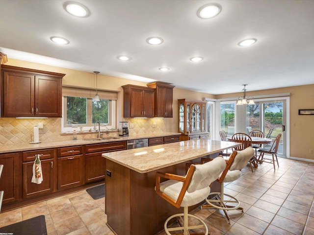 1008 Hidden Ln, Rochester Hills, MI 48309 - kitchen with dishwasher, a kitchen island, a kitchen bar, tasteful backsplash, and light stone counters