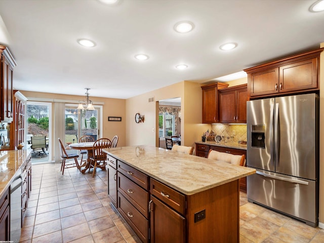 1008 Hidden Ln, Rochester Hills, MI 48309 - kitchen with stainless steel fridge with ice dispenser, a center island, decorative backsplash, light stone countertops, and recessed lighting