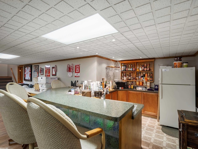 1008 Hidden Ln, Rochester Hills, MI 48309 - kitchen featuring freestanding refrigerator, ornamental molding, brown cabinets, a peninsula, and open shelves
