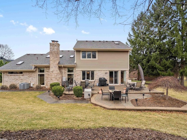 1008 Hidden Ln, Rochester Hills, MI 48309 - rear view of house with a patio, a yard, brick siding, a chimney, and a shingled roof