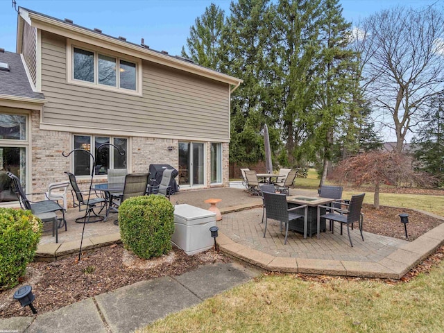 1008 Hidden Ln, Rochester Hills, MI 48309 - rear view of property featuring outdoor dining space, a patio area, and brick siding