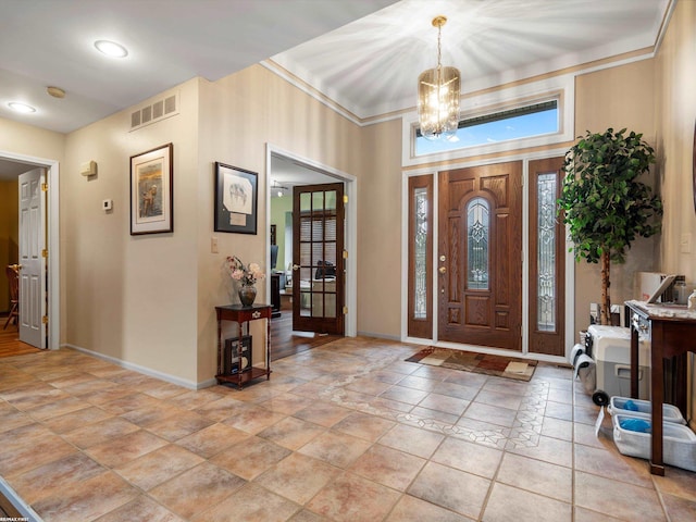 1008 Hidden Ln, Rochester Hills, MI 48309 - foyer featuring a chandelier and light stone finish floors