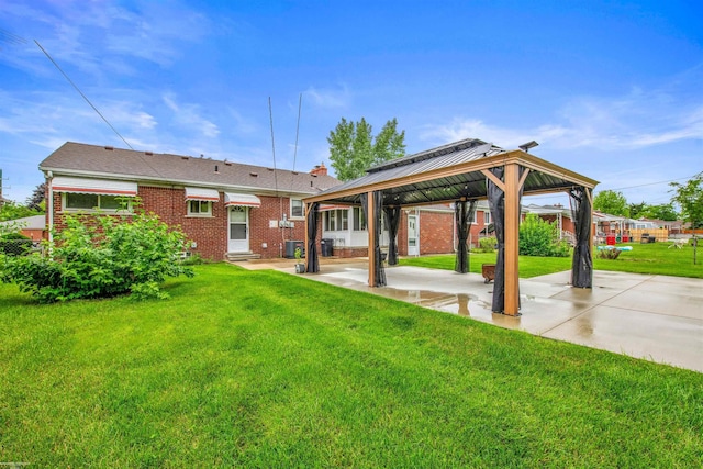 23716 Roxana Ave, Eastpointe, MI 48021 - rear view of property with a gazebo, a yard, brick siding, a patio area, and a chimney