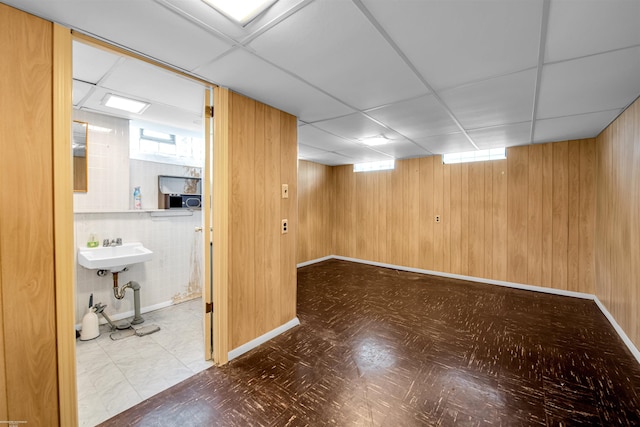 23716 Roxana Ave, Eastpointe, MI 48021 - basement featuring tile patterned floors, wooden walls, and a drop ceiling
