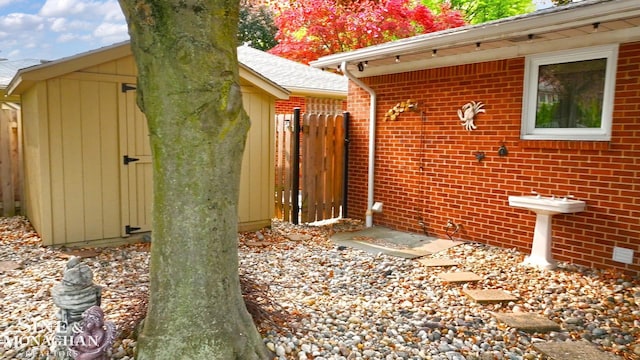 528 Hidden Ln, Grosse Pointe Woods, MI 48236 - view of side of home featuring brick siding and a storage unit