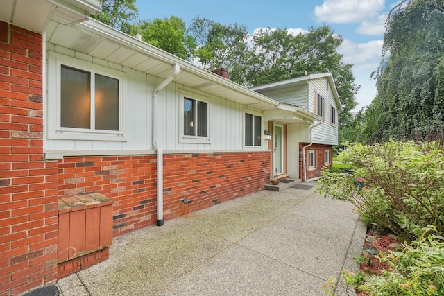 6575 Goldfinch Ln, Clarkston, MI 48346 - view of side of property featuring brick siding, a patio, and board and batten siding