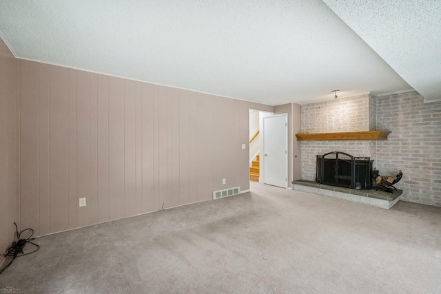 6575 Goldfinch Ln, Clarkston, MI 48346 - unfurnished living room featuring a fireplace, carpet floors, stairs, and a textured ceiling