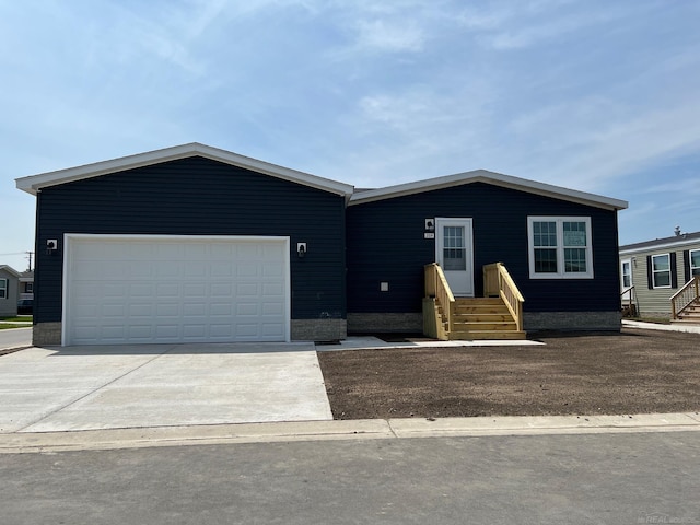 264 Westbrook Ct, Port Huron, MI 48060 - manufactured / mobile home with concrete driveway and a garage
