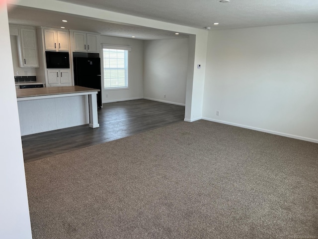 264 Westbrook Ct, Port Huron, MI 48060 - kitchen with dark carpet, freestanding refrigerator, recessed lighting, open floor plan, and dark wood-type flooring