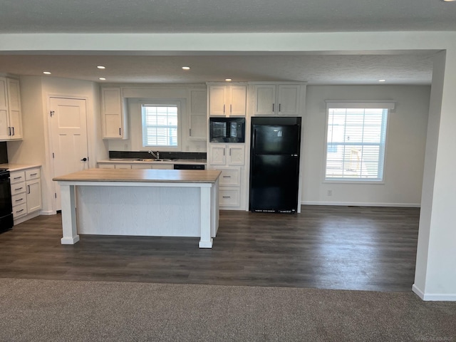 264 Westbrook Ct, Port Huron, MI 48060 - kitchen featuring black appliances, a kitchen island, recessed lighting, dark wood finished floors, and white cabinets