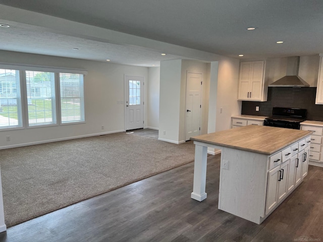 264 Westbrook Ct, Port Huron, MI 48060 - kitchen with black range with electric cooktop, wall chimney exhaust hood, recessed lighting, white cabinets, and light countertops